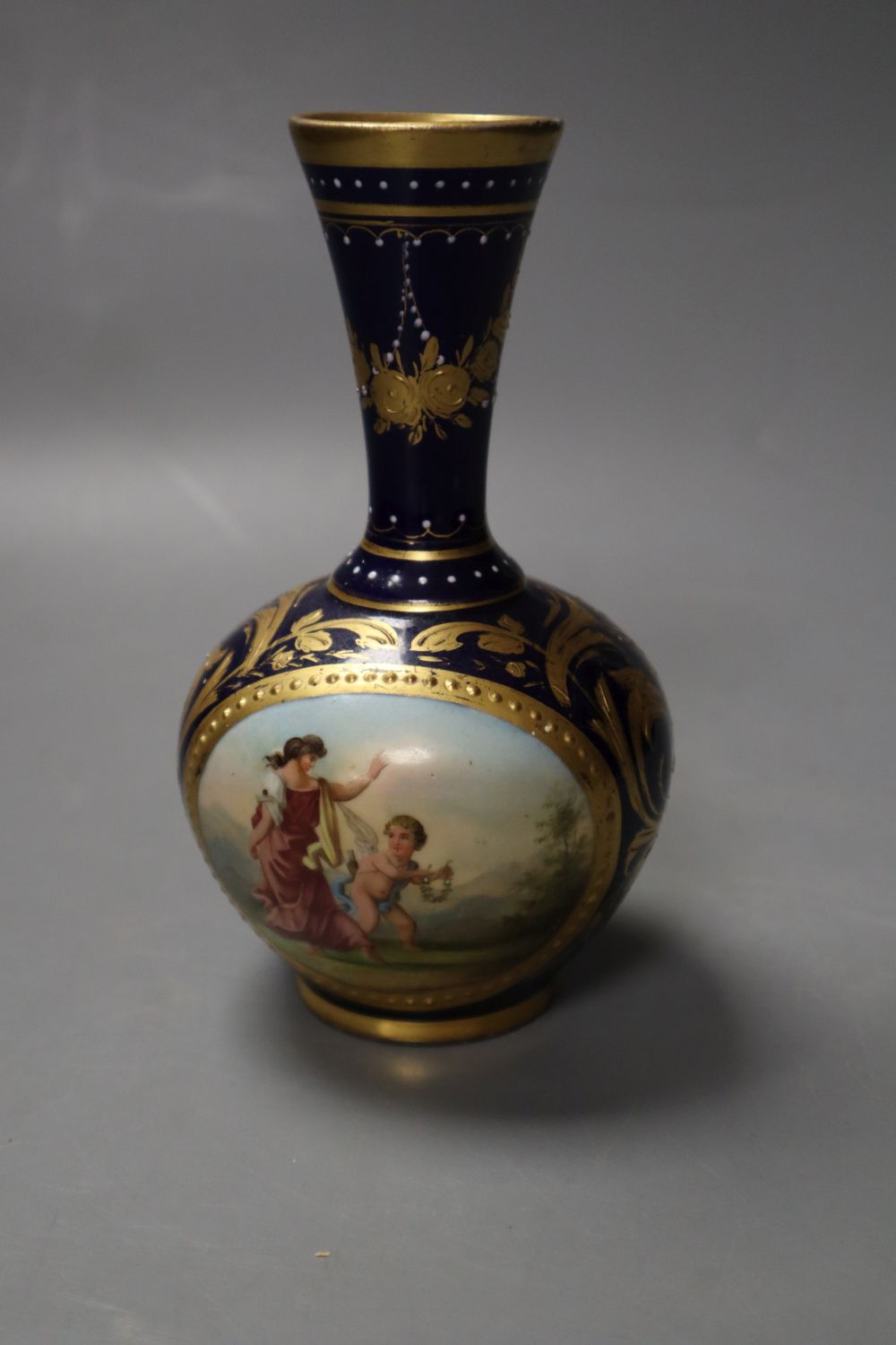 A Vienna vase painted with a woman and children on a blue and gilt ground, 14cm